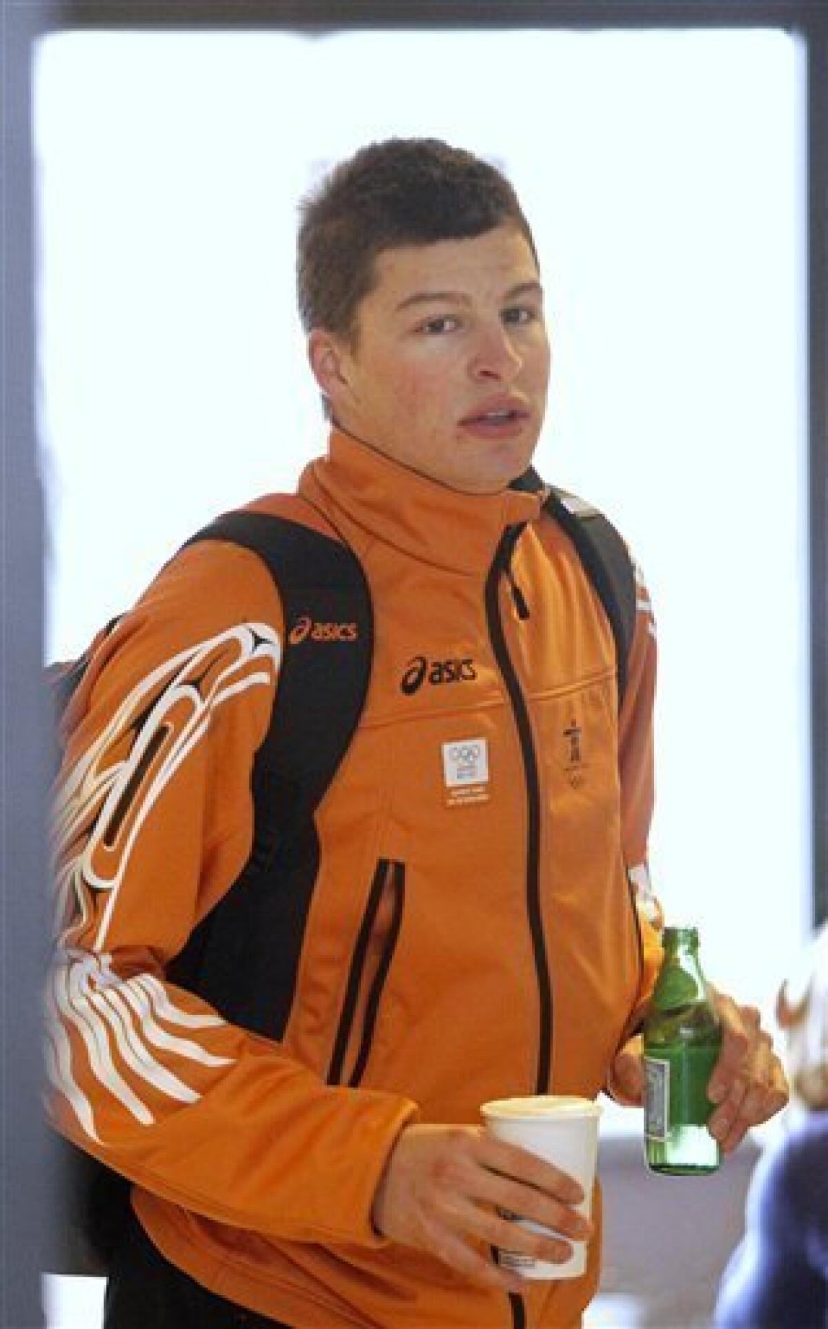 Dutch speed skater Sven Kramer holds refreshments in a hotel lobby in Richmond, at the Vancouver 2010 Olympics in Vancouver, British Columbia, Wednesday, Feb. 24, 2010. Kramer went through the grueling 10,000-meter race Tuesday in what would have been record time, but was disqualified for not switching lanes while coming out of a turn about two-thirds into the race. Here's the craziest part: Kramer actually made the switch but his coach missed it. Thinking his star was about to make an epic mistake, the coach animatedly motioned for Kramer to switch lanes. Kramer seemed to pause before deciding to follow orders. (AP Photo/Matt Dunham)