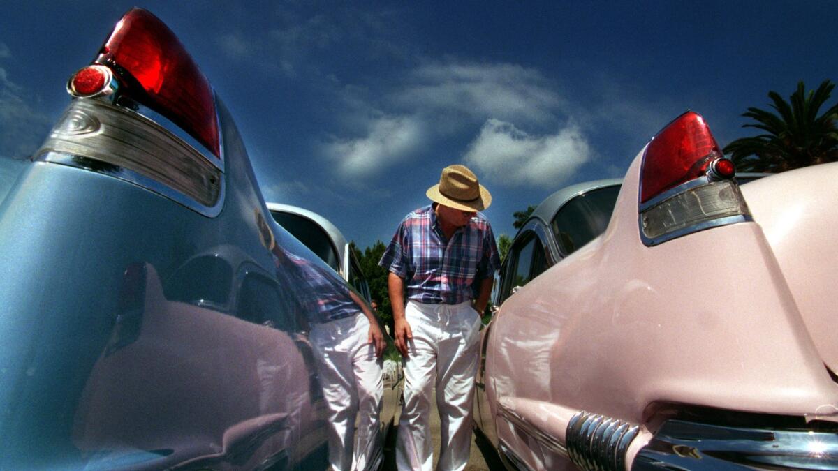 Two Cadillacs -- a 1954 Coupe, left, and a 1956 Sedan De Ville -- at auction in 1997. The man responsible for their look was Harley Earl.