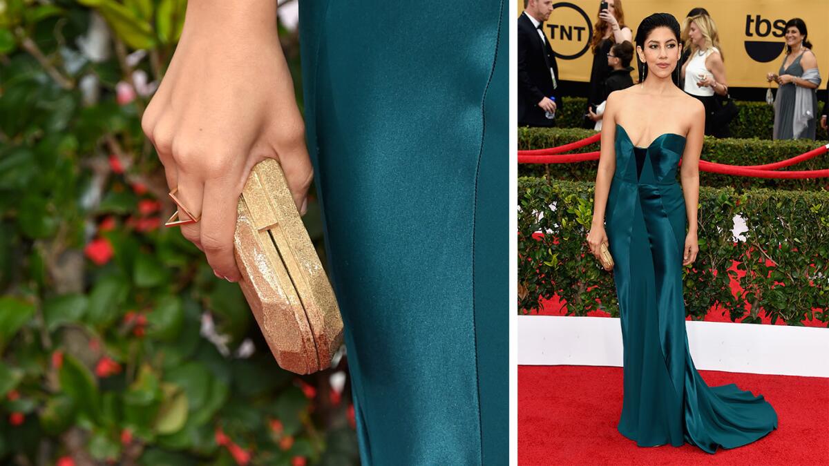 Stephanie Beatriz carries a Corto Moltedo "Susan Desny" clutch in Gold Moon.