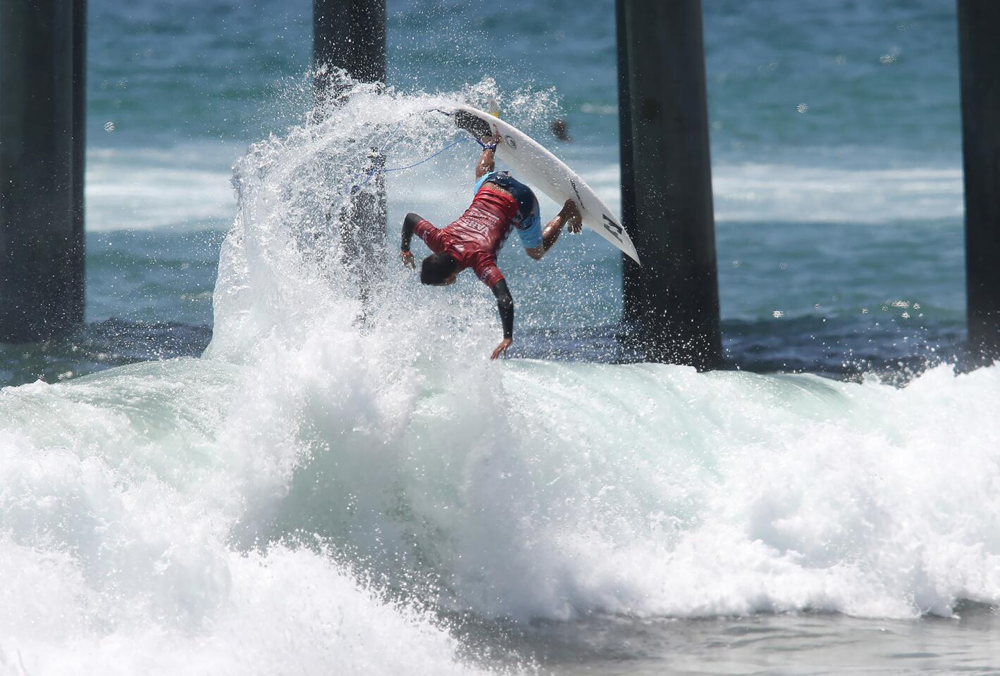 Seth Moniz completes an almost upside down backside air reverse in round 5 of the Men's US Open of Surfing on Saturday.