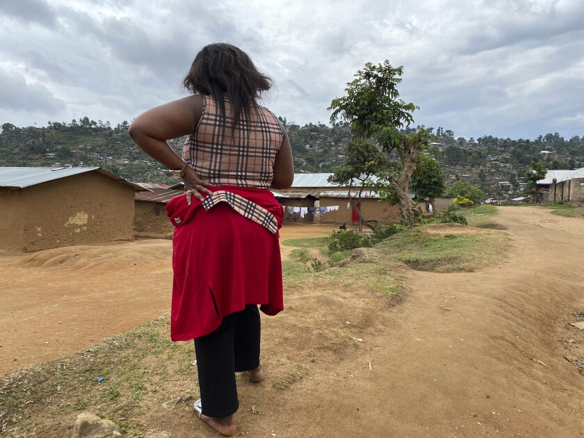 Shekinah stands near her home in Beni, eastern Congo on Thursday, March 18, 2021. When she was working as a nurse’s aide in northeastern Congo in January 2019, she said World Health Organization Dr. Boubacar Diallo, of Canada, offered her a job investigating Ebola cases at double her previous salary _ with a catch. "When he asked me to sleep with him, given the financial difficulties of my family….I accepted.” (AP Photo/Kudra Maliro)