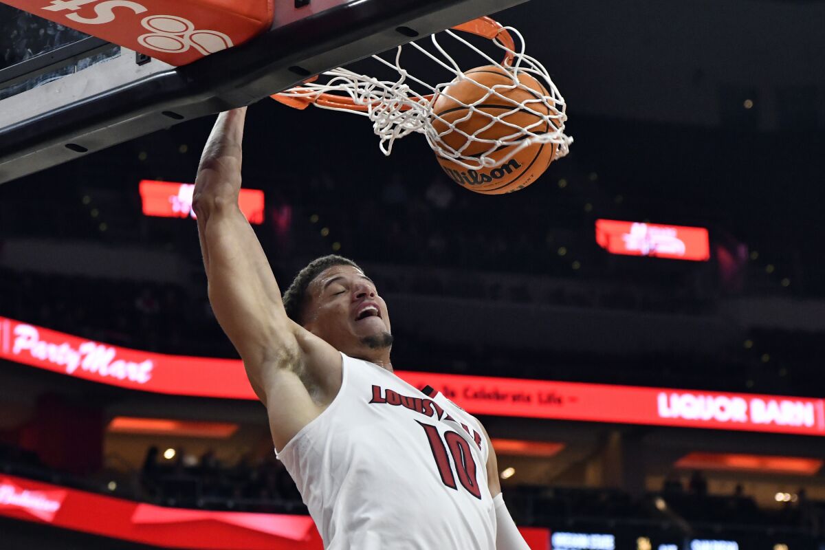 Louisville forward Samuell Williamson (10) dunks the ball during the second half of an NCAA college basketball game against Navy in Louisville, Ky., Monday, Nov. 15, 2021. Louisville won 77-60. (AP Photo/Timothy D. Easley)