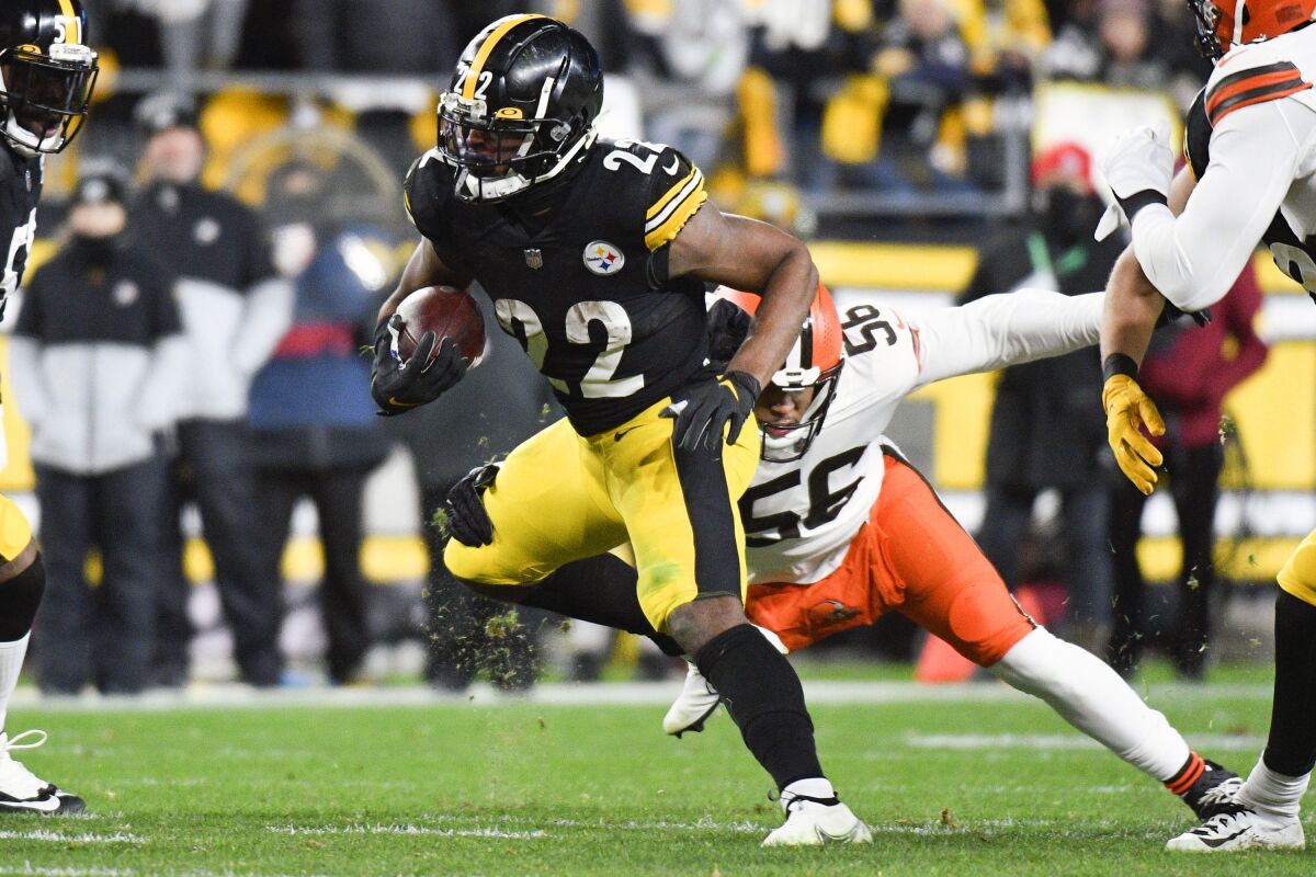 Pittsburgh Steelers running back Najee Harris (22) tries to get loose from Cleveland Browns middle linebacker Malcolm Smith (56) during the first half an NFL football game, Monday, Jan. 3, 2022, in Pittsburgh. (AP Photo/Don Wright)