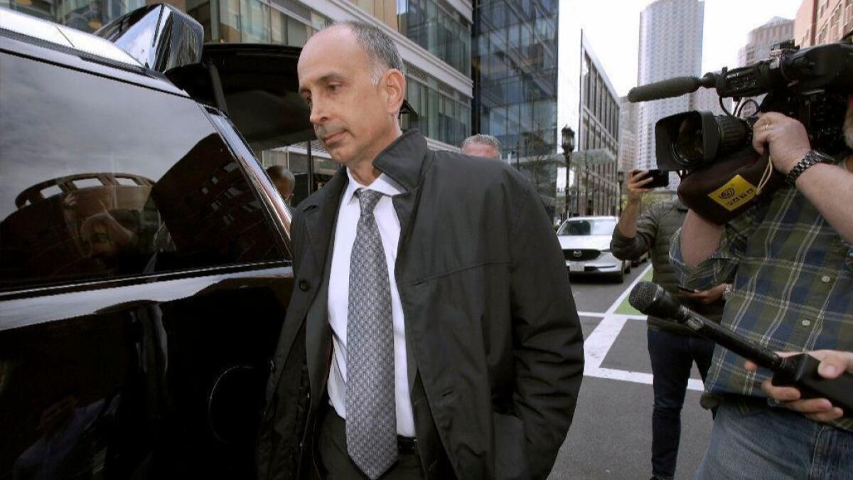 California businessman Stephen Semprevivo departs federal court on May 7 in Boston after pleading guilty to charges that he bribed the Georgetown tennis coach to get his son admitted to the school.