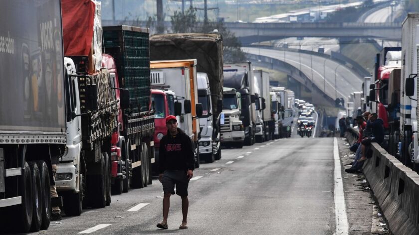 Truck drivers block a major road in Sao Paulo on Saturday as part of a nationwide strike to protest rising fuel costs. The strike has left much of Brazil paralyzed.