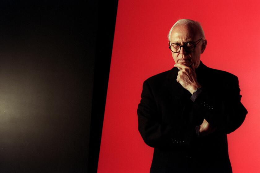 Ellsworth Kelly is photographed in front of one of his works at Peter Carlson Enterprises in Sun Valley in 1996.