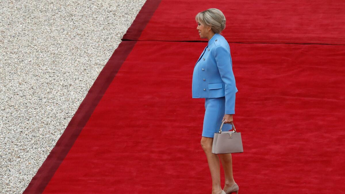 Brigitte Trogneux wears Louis Vuitton at the presidential palace for her husband's inauguration ceremony.
