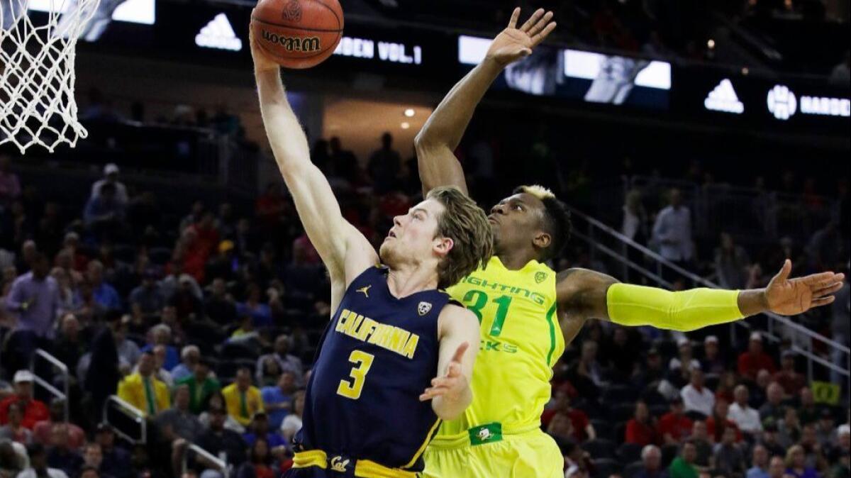 Oregon's Dylan Ennis fouls California's Grant Mullins during the second half of a Pac-12 tournament semifinal game on March 10.