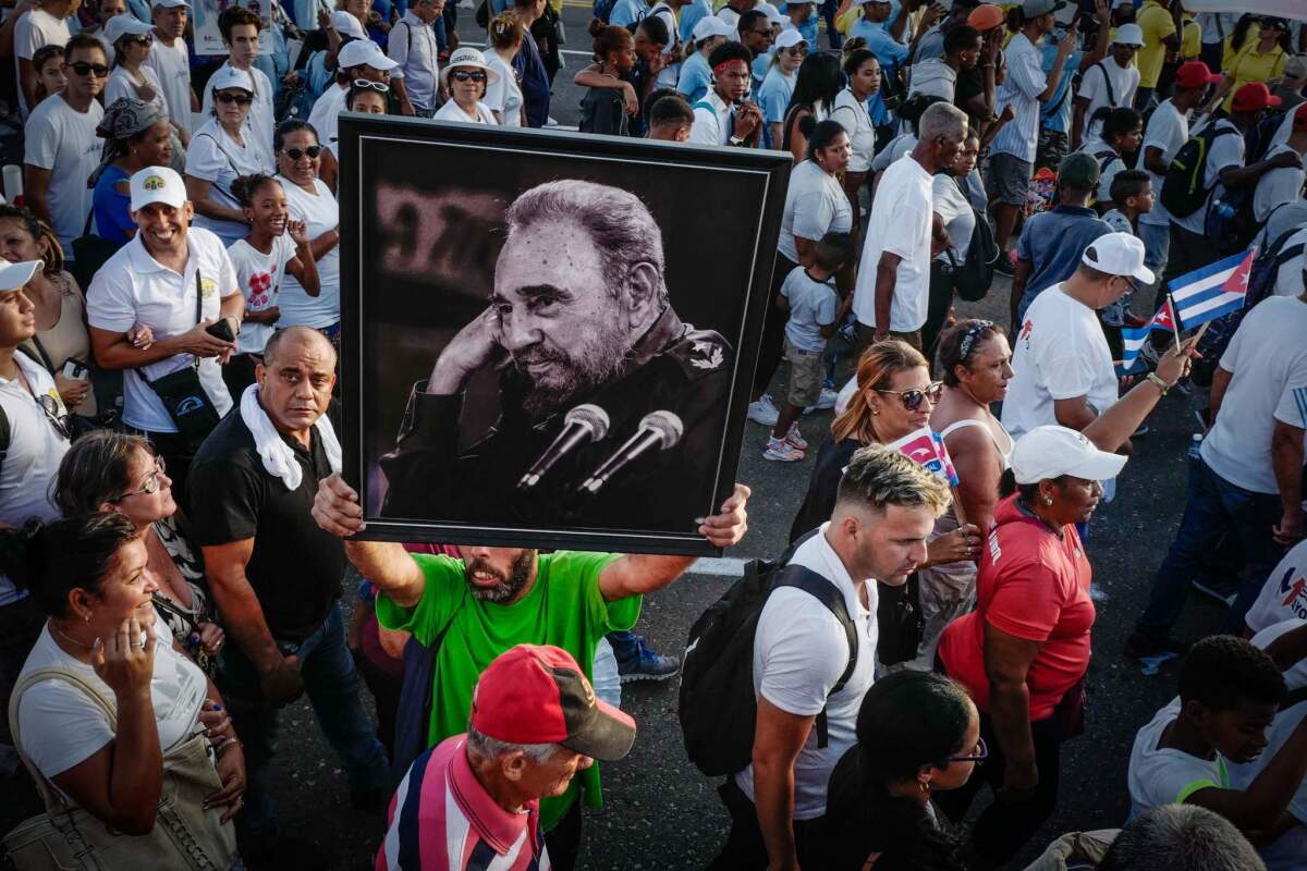 A poster of former Cuban leader Fidel Castro is held aloft at a May Day rally at Havana's Revolution Square. (Adalberto Roque / AFP/Getty Images)