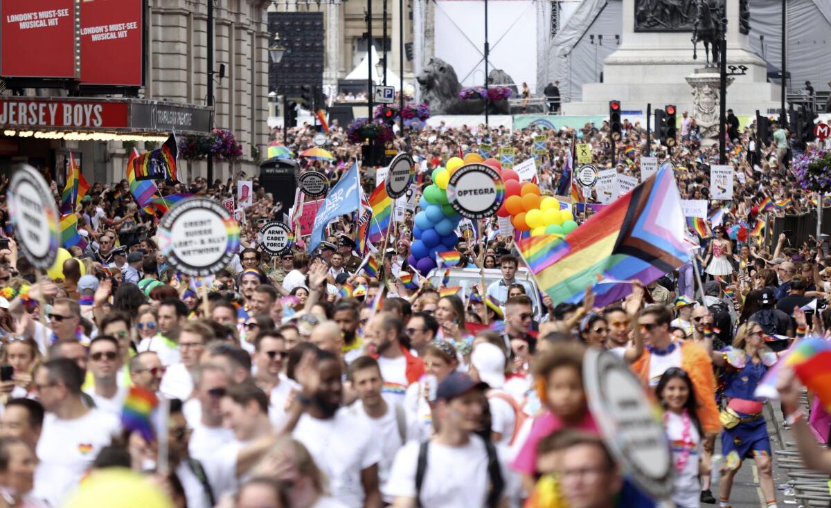 People take part in the Pride rally in London, Saturday July 2, 2022. The U.K. capital marked 50 years of Pride as a vibrant crowd of hundreds of thousands turned out to either take part in or watch the festivities, forming a spectacle of rainbow flags, glitter and sequins. After two years of cancellations because of the coronavirus pandemic, the parade came a half-century after London’s first march to celebrate Pride in 1972. (James Manning/PA via AP)