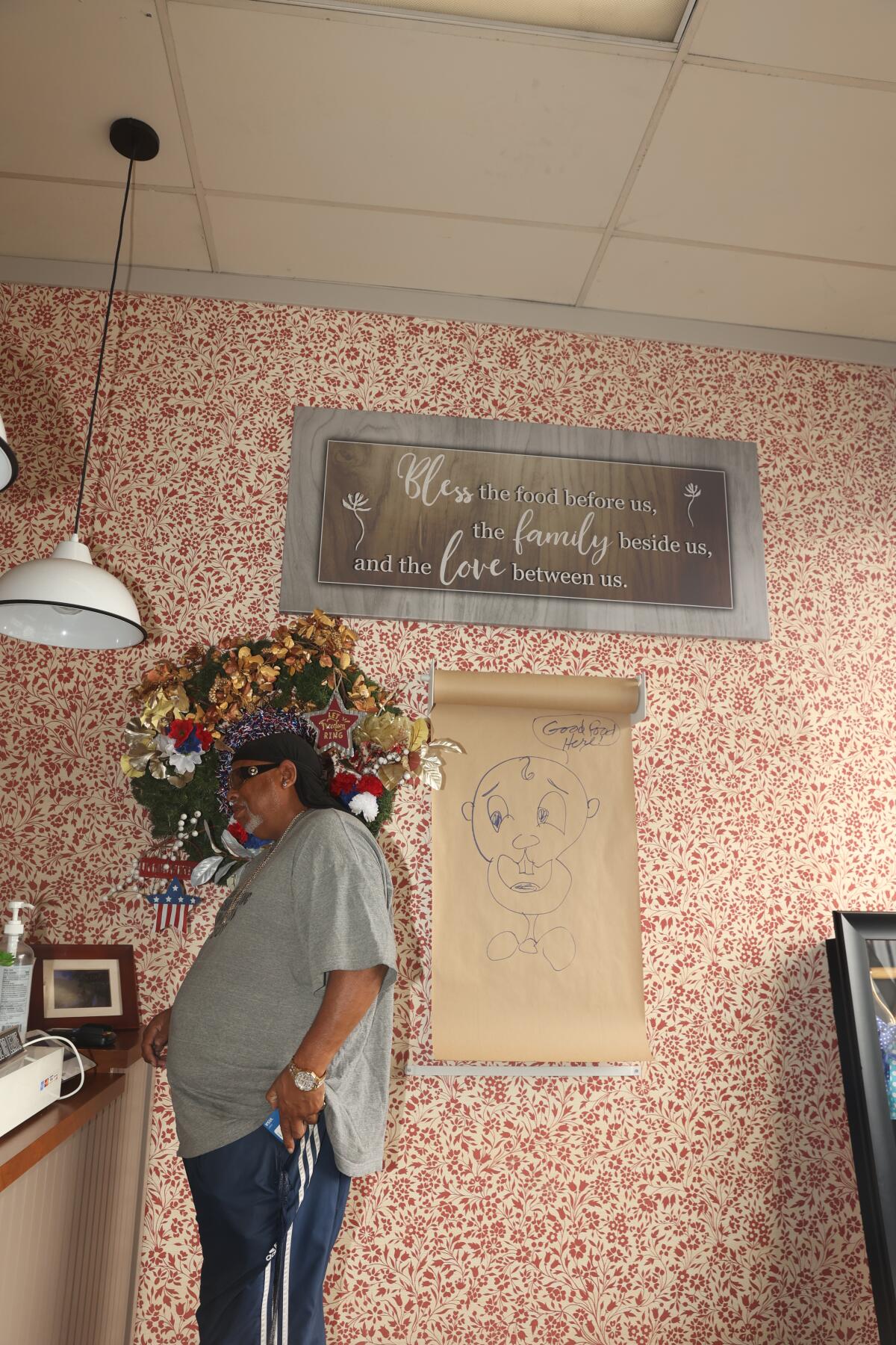 A man places an order at Alma's Place in Compton.