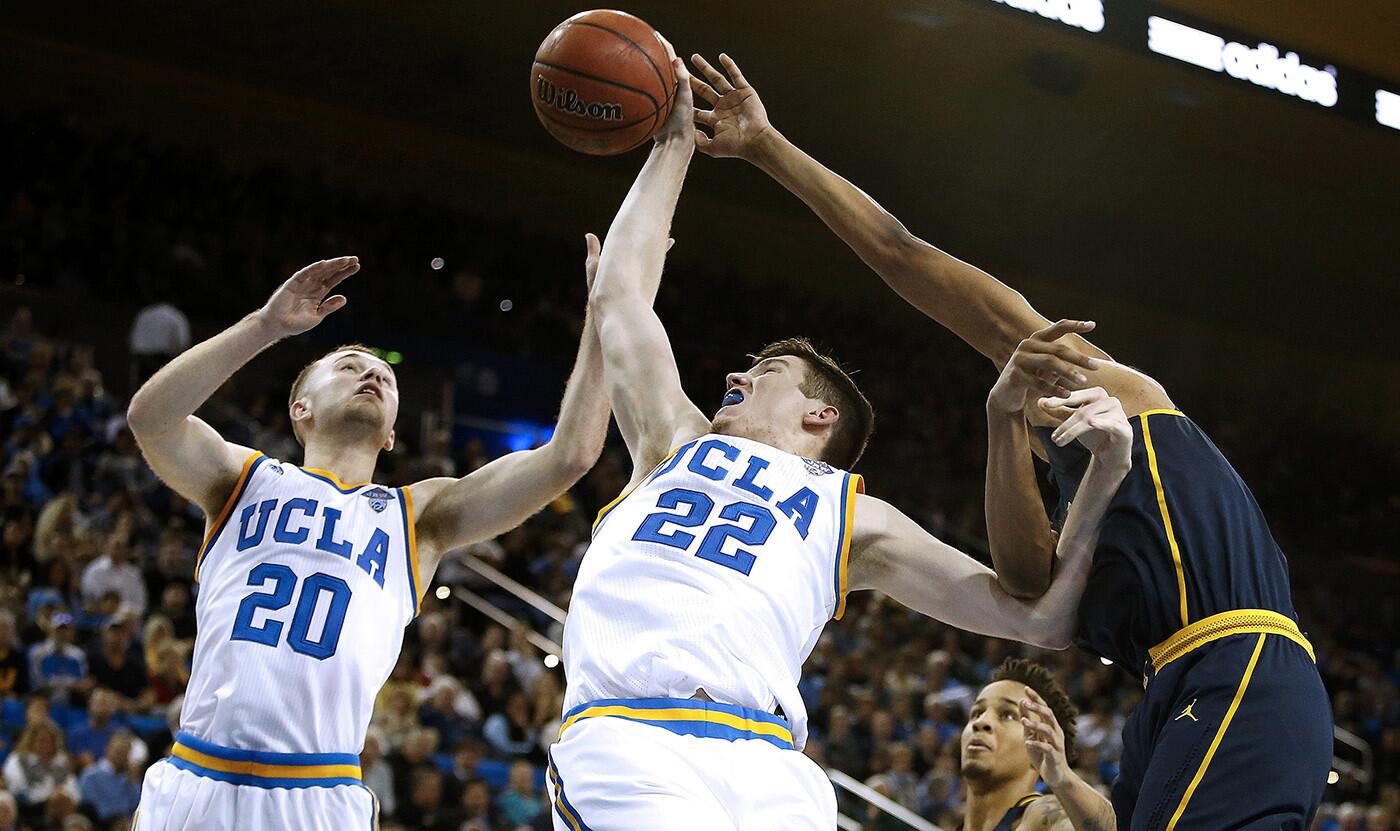 UCLA guard Bryce Alford (20), and forward TJ Leaf (22) fight for a rebound with Californiaforward Ivan Rabb duringthe second half.