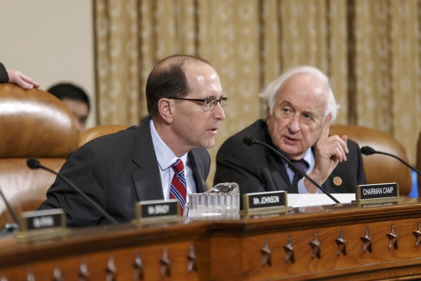 House Ways and Means Committee Chairman Dave Camp (R-Mich.) and ranking member Rep. Sander M. Levin (D-Mich.), right, exchange words before the panel recommended an investigation of alleged criminal actions by former IRS official Lois Lerner.