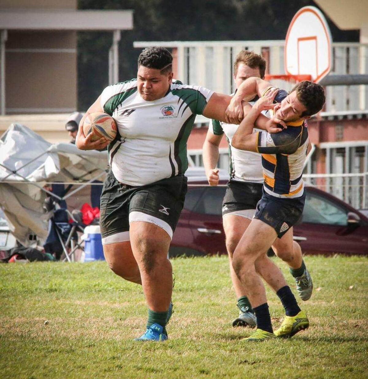 Atonio Mafi stiff-arms a competitor during his rugby playing days.