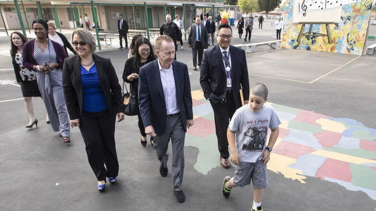 Recently hired L.A. schools Supt. Austin Beutner, center, is seeking to bring in new funding from local foundations.