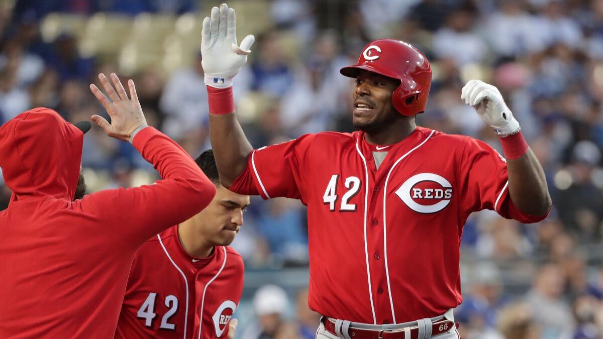 Cincinnati Reds Yasiel Puig outfielder celebrates after hitting a two-run homer off Dodgers starter Clayton Kershaw during the first inning of Monday's game.