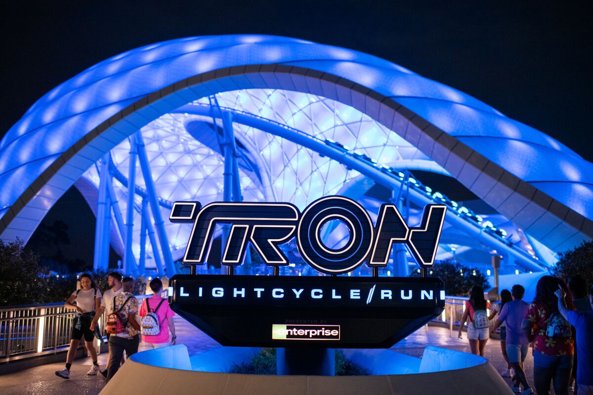 Above the words Tron Lightcycle / Run is a bright blue umbrella