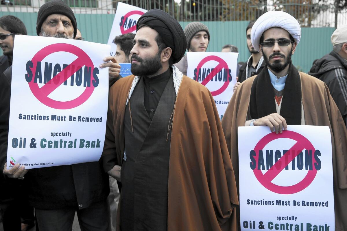 Two clergymen and others show their support for Iran’s nuclear program in front of the country’s Atomic Energy Organization in Tehran on Nov. 23.