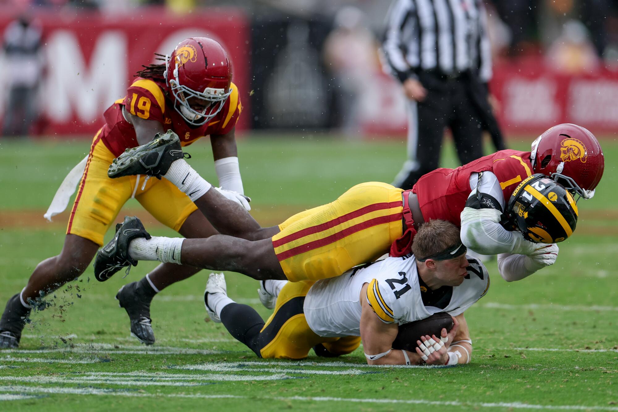 USC defensive end Kameryn Crawford tackles Iowa wide receiver Kaden Wetjen at the Coliseum on Saturday.
