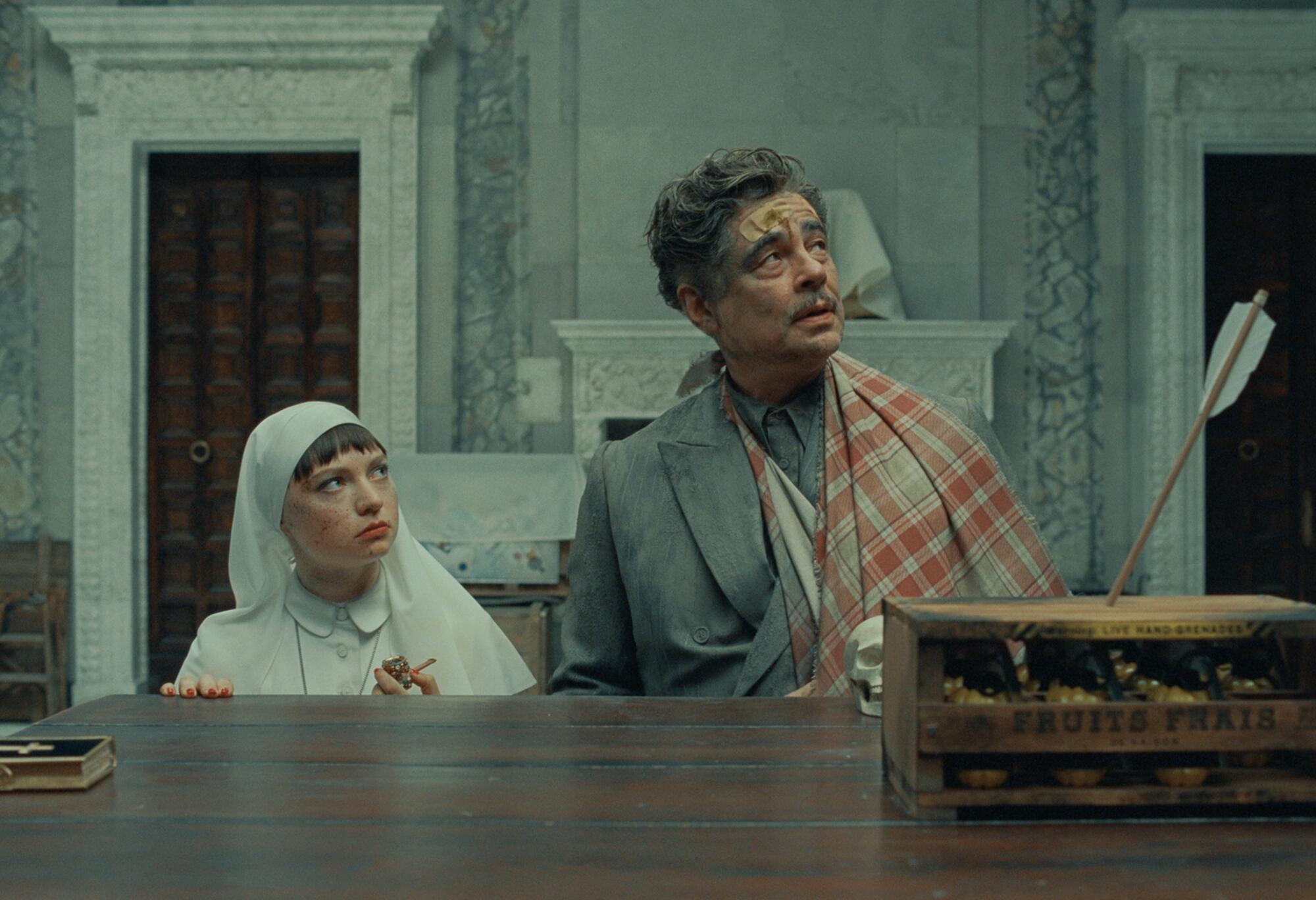 A nun and a man in an arm sling look up as an arrow is shot at them.