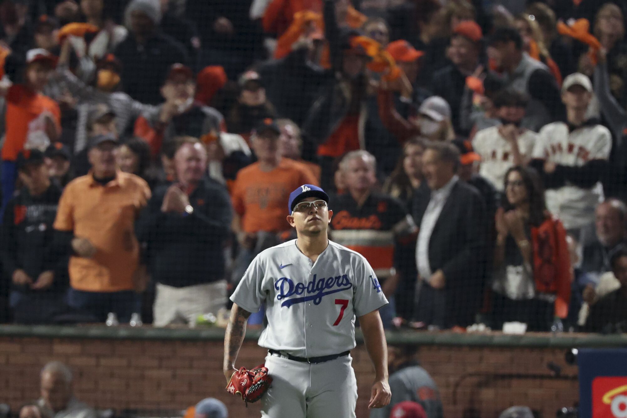 Dodgers pitcher Julio Urias looks up after allowing a base hit to Giants' Brandon Crawford