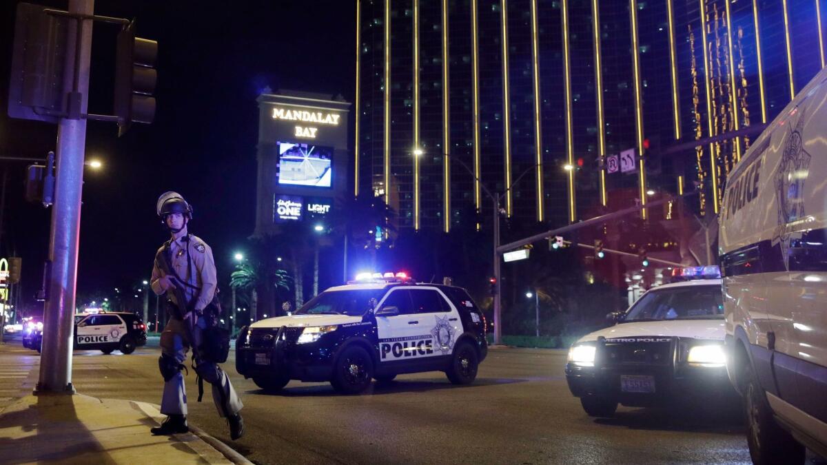 Police officers stand along the Las Vegas Strip outside the Mandalay Bay Resort and Casino during a shooting near the casino, Sunday, Oct. 1, 2017, in Las Vegas.