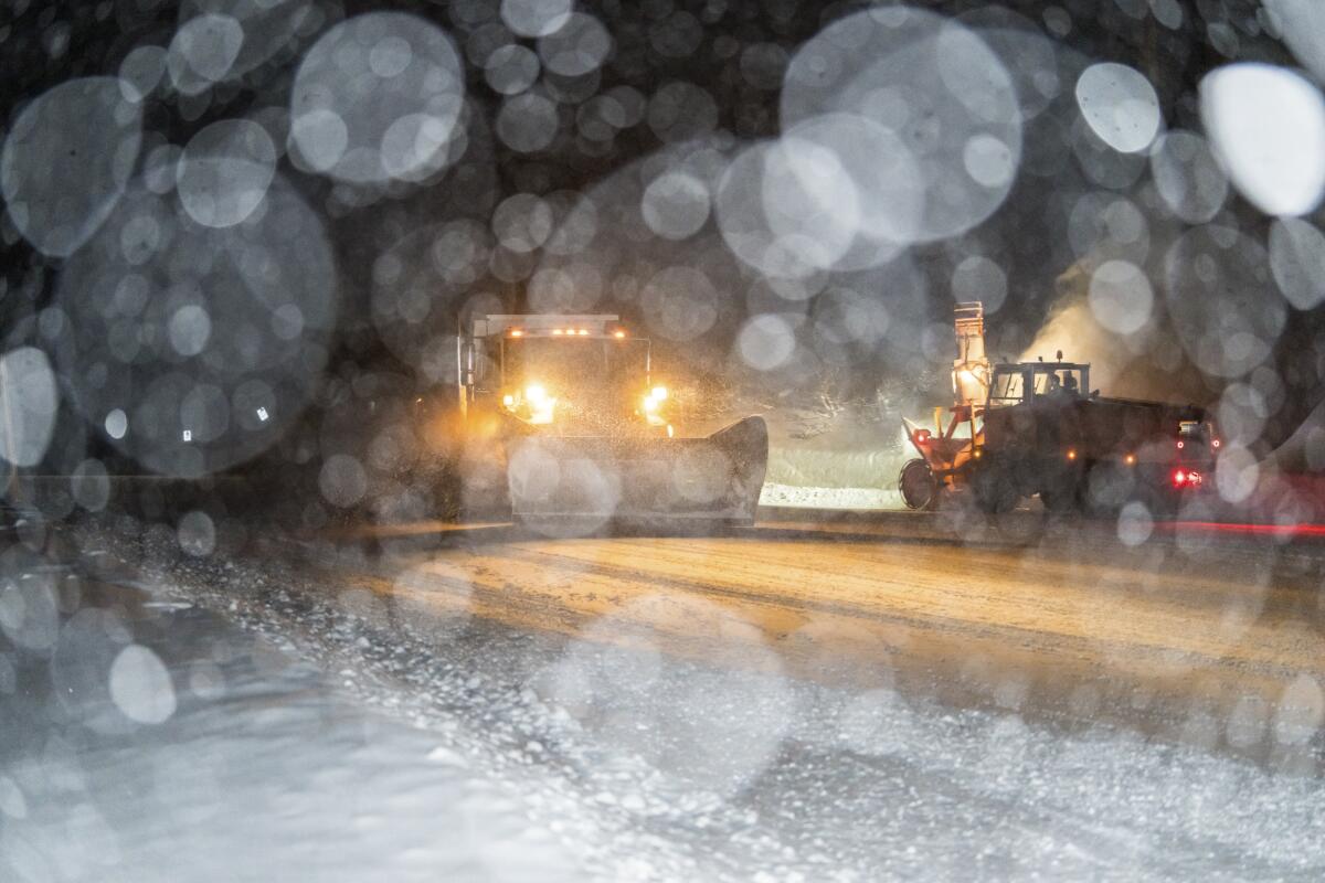 Snow plows on a snowy road