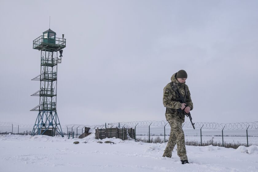 A Ukrainian border guard patrols the border with Russia.