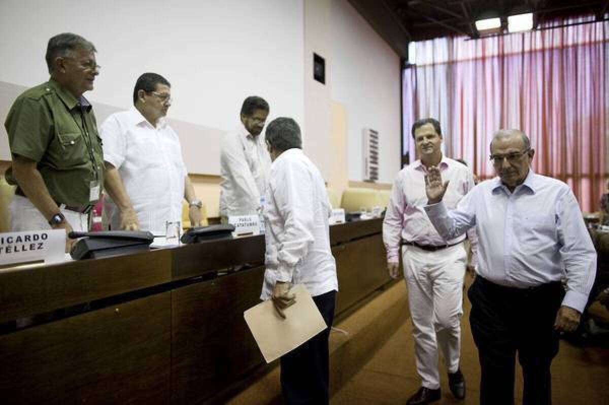 Humberto de la Calle, right, head of the Colombian government's peace negotiation team, greets FARC members, from left, Ricardo Tellez, Pablo Catatumbo and Ivan Marquez during their peace talks in Cuba.