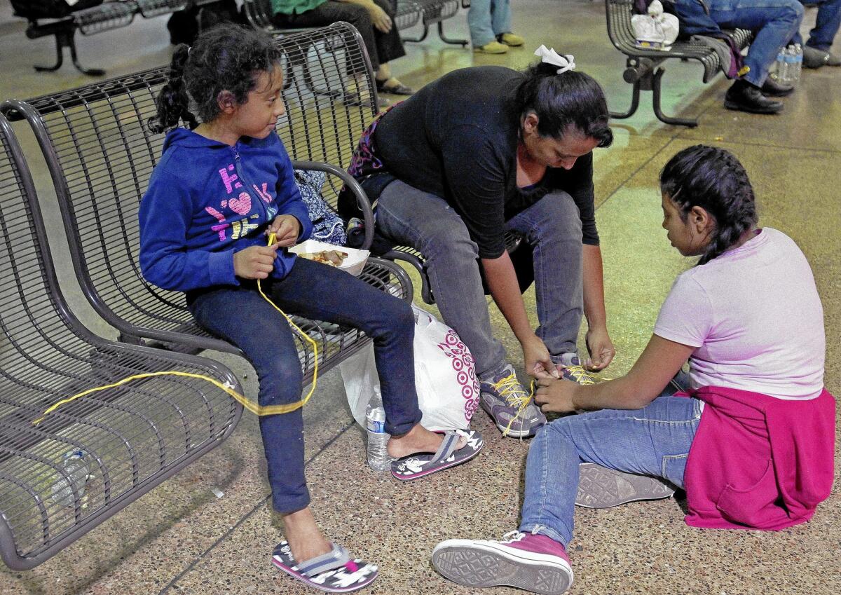 Elana Carmen and her daughters at a bus terminal in Phoenix. About 400 mostly Central American women and children caught crossing from Mexico into south Texas were taken to Arizona in May after border agents there ran out of space and resources.