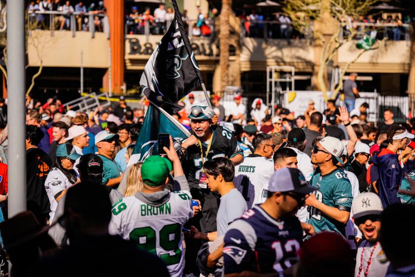 Eagles fans gather in the street outside McFadden's Restaurant and Saloon in Glendale before the Super Bowl.
