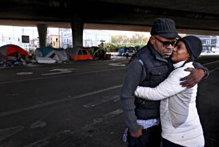 OAKLAND, CA - OCT. 9: Raymond Joseph, 56, holds his fianceé Regina Carter, 40, at their encampment off of Martin Luther King Jr Way and 23rd Street in Oakland, Calif., on Friday, October 9, 2020. The couple are expecting a baby in seven months. The couple would like to have permanent housing before their baby arrives. Oakland is in the midst of the worst homelessness crisis the city has ever seen. Overall homelessness in Oakland increased by 47% with a 68% increase from 2017 to 2019 in the number of unsheltered people from 1,902 to 3,210 people. There are an estimated 60 encampments of three or more people in Oakland with approximately 730 total people living in the encampments. (Yalonda M. James/The San Francisco Chronicle via Getty Images)
