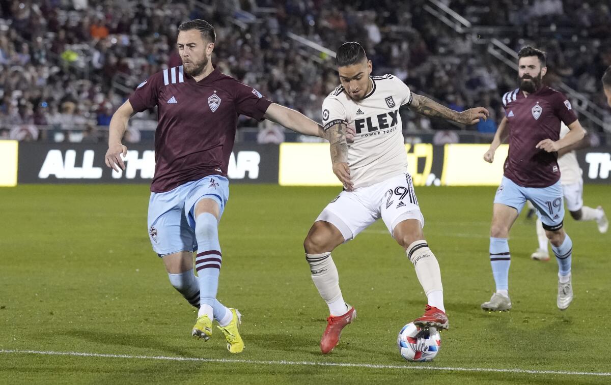 Rapids defender Danny Wilson, left, covers LAFC forward Cristian Arango who drives with the ball toward the net 