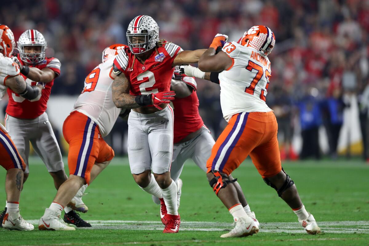 Clemson's Tremayne Anchrum (73) tries to hold off Ohio State end Chase Young, the second pick of the NFL draft.