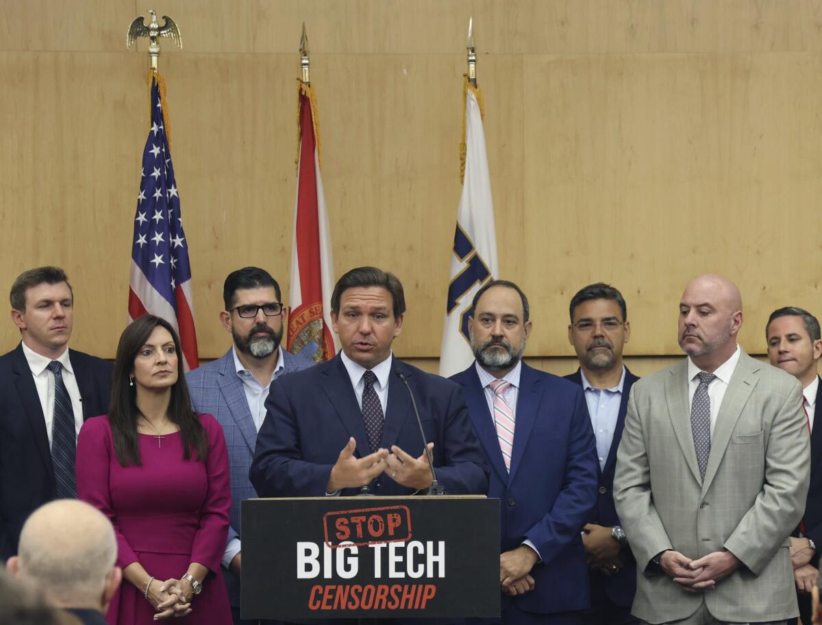 Florida Gov. Ron DeSantis flanked by legislators and a sign reading "Stop Big Tech censorship."