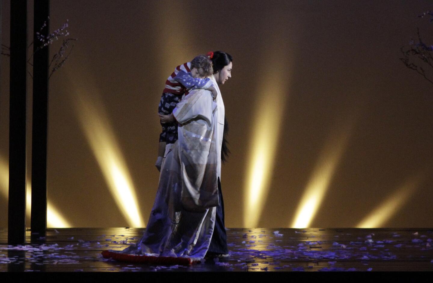 Oksana Dyka (Cio-Cio-San) and Garret Chang (Cio-Cio-San's child) in L.A. Opera's new production of Puccini's "Madame Butterfly" at the Dorothy Chandler Pavilion.