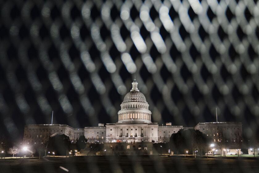 WASHINGTON, DC - FEBRUARY 27: The Dome of the U.S. Capitol Building is seen through security fencing on Sunday, Feb. 27, 2022 in Washington, DC. Temporary fencing is being reinstalled around the U.S. Capitol as federal security officials brace for protesting truckers to reach the Washington DC area, potentially coinciding with President Joe Biden's State of the Union Address on Tuesday. (Kent Nishimura / Los Angeles Times)