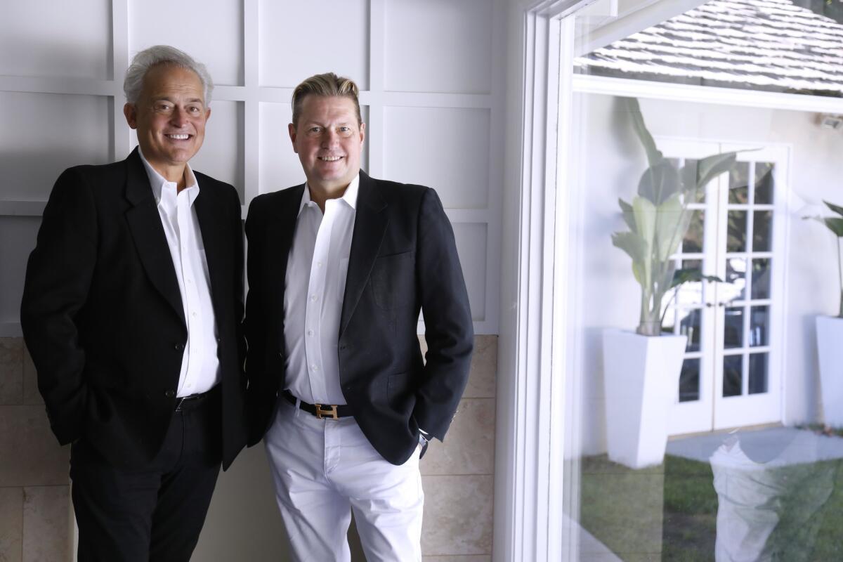 Fashion designers Mark Badgley, left, and James Mischka at their home in Beverly Hills.