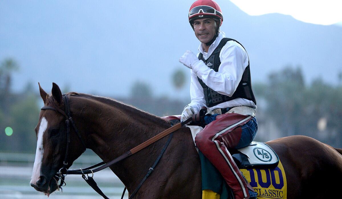 Willie Delgado leads California Chrome off the track after workout on Oct. 29 at Santa Anita Park.