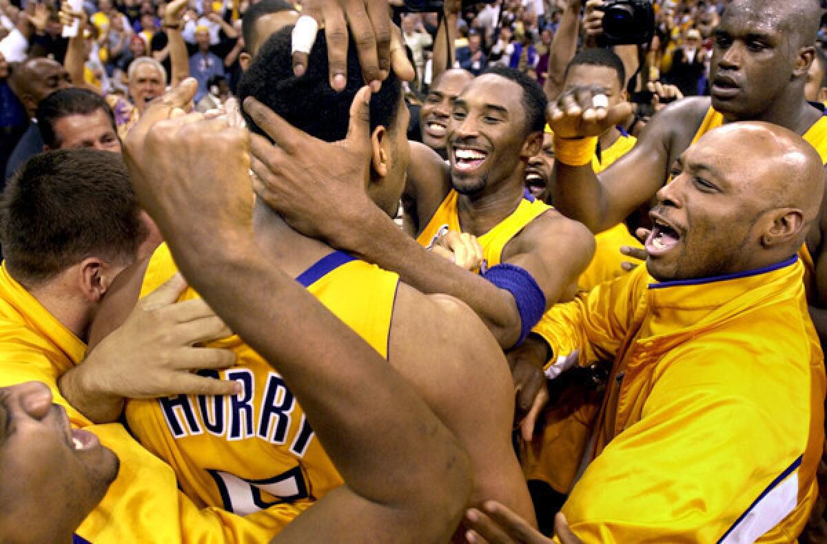 Robert Horry is mobbed by Kobe Bryant and other Lakers after making the winning shot against Sacramento in the 2002 playoffs.