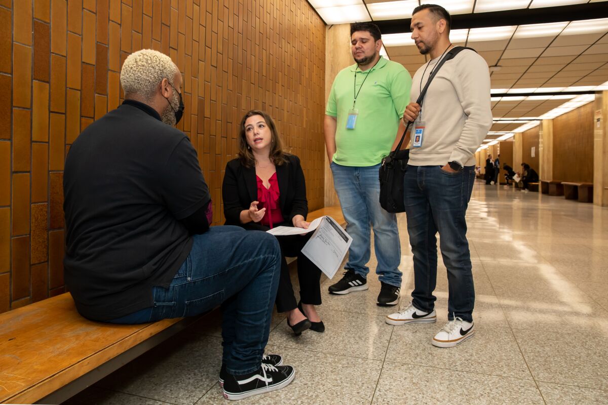 Coordinator for the Rapid Diversion Program and Public defender Caroline Goodson consults with a client 