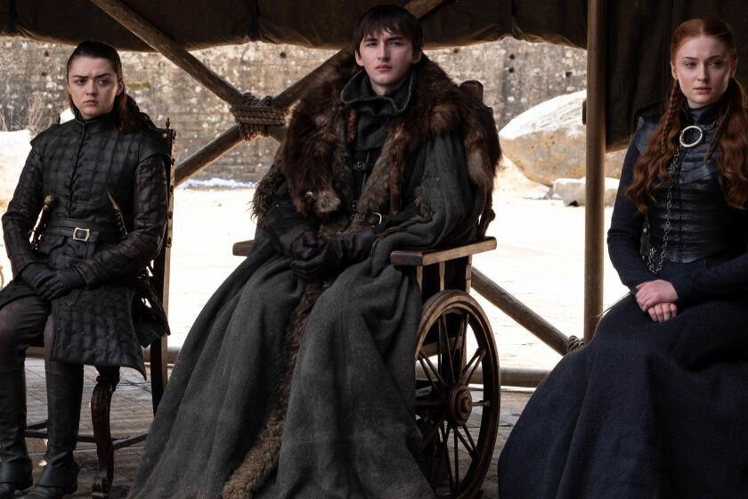 This image released by HBO shows from left to right Maisie Williams, Isaac Hempstead Wright and Sophie Turner in a scene from the final episode of "Game of Thrones," that aired Sunday, May 19, 2019. (HBO via AP)