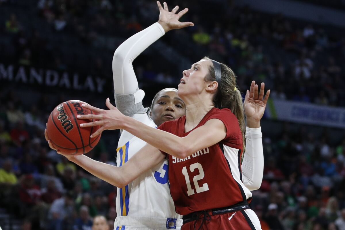 Stanford's Lexie Hull puts up a shot around UCLA's Lauryn Miller in their Pac-12 tournament semifinal game March 7, 2020, in Las Vegas.