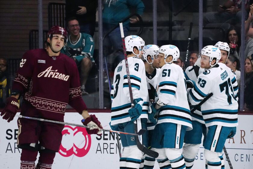 San Jose Sharks center Noah Gregor (73) celebrates his goal with defensemen Radim Simek (51) and Henry Thrun (3), right wing Kevin Labanc, third from left, and center Nico Sturm, back right, as Arizona Coyotes center Jack McBain (22) skates past during the first period of an NHL hockey game Saturday, April 1, 2023, in Tempe, Ariz. (AP Photo/Ross D. Franklin)