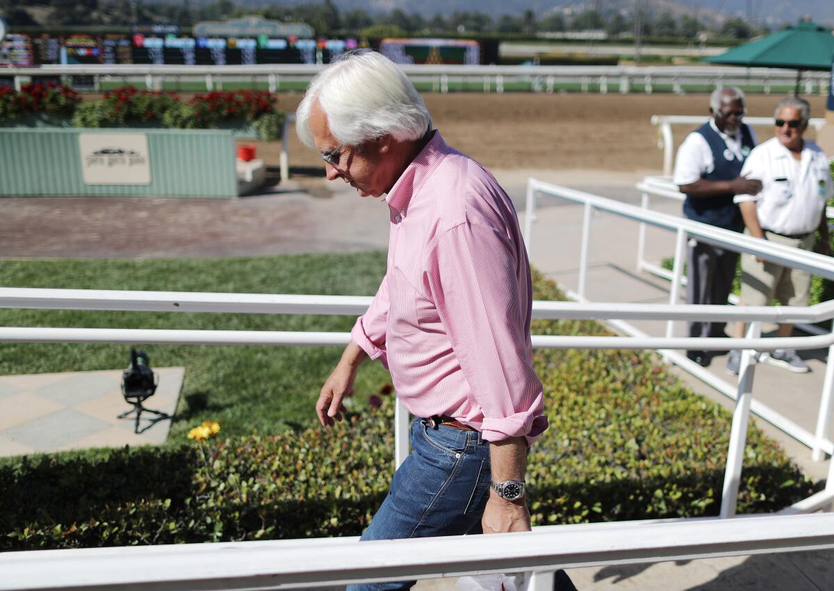 Trainer Bob Baffert departs the winner's circle at Santa Anita Park on June 2019.