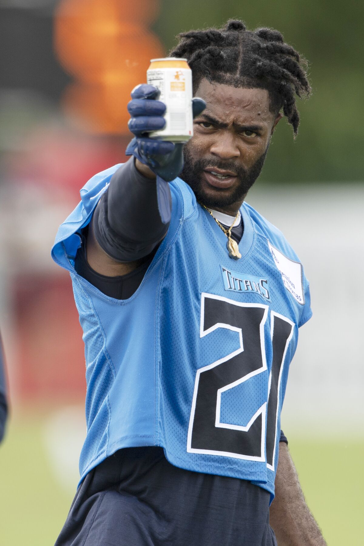 Tennessee Titans cornerback Malcolm Butler (21) takes a drink during NFL football training camp Friday, Aug. 14, 2020, in Nashville, Tenn. (George Walker IV/Pool Photo via AP)