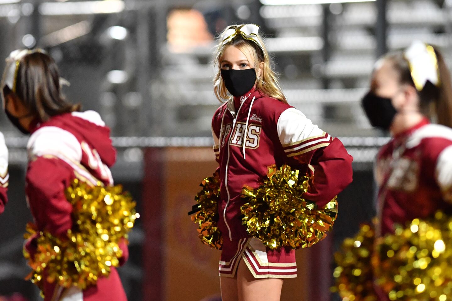 Cheerleaders wore masks to root on the squad.