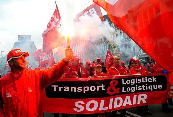 Demonstrators protest in front of the stock exchange in Brussels during a protest to demand action to combat the economic crisis and rising unemployment. The demonstration was one in a series of protests set to take place in Europe in response to a call by the European Trade Union Confederation.