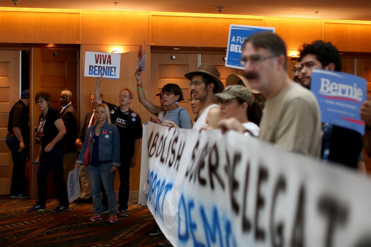 Supporters chant for Democratic presidential candidate Bernie Sanders at a state party gathering at the Long Beach Convention and Entertainment Center.