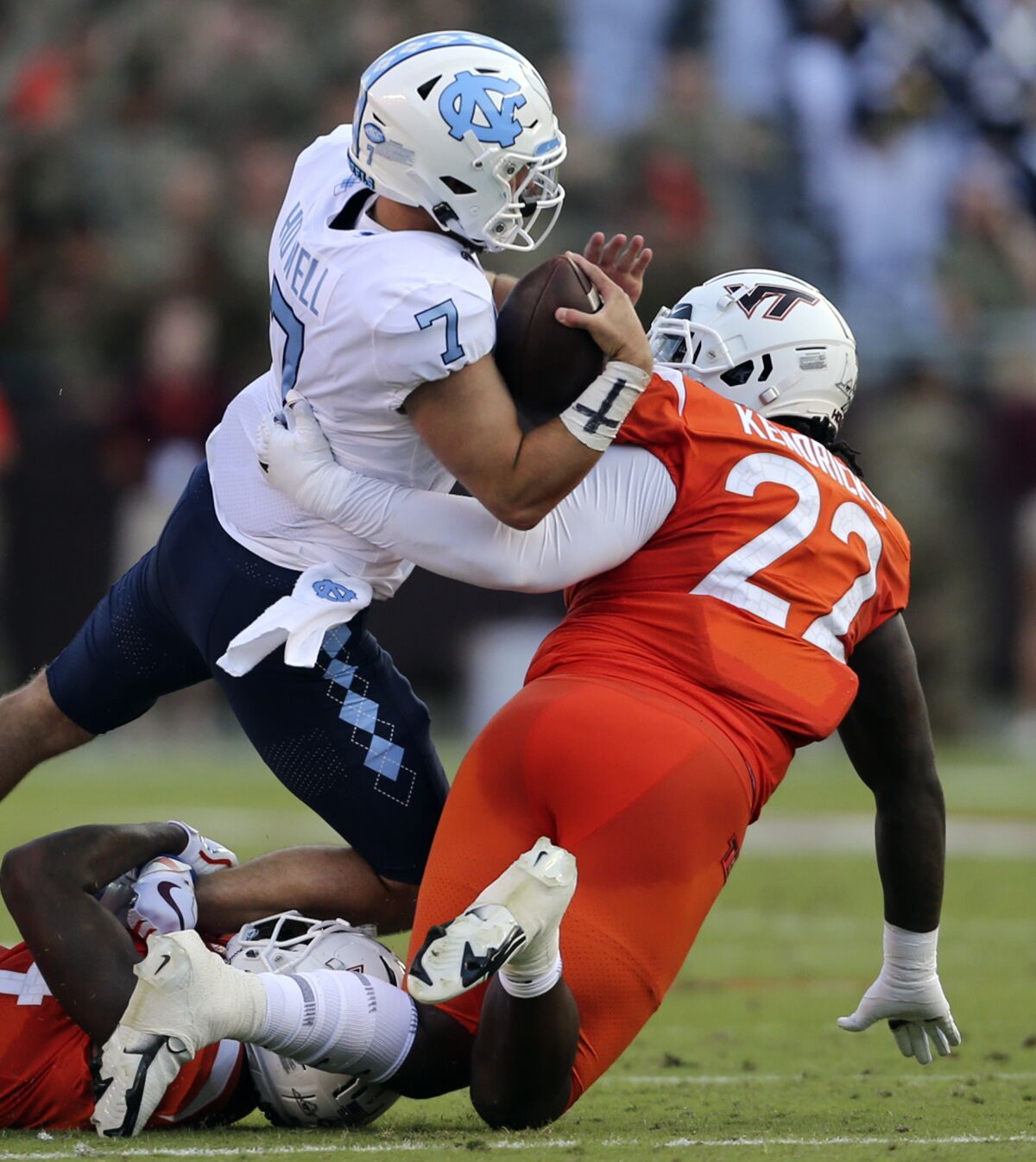 North Carolina quarterback Sam Howell (7) is sacked by Virginia Tech's Chamarri Conner (22) during the first half of an NCAA college football game Friday, Sept. 3, 2021, in Blacksburg, Va. (Matt Gentry/The Roanoke Times via AP)
